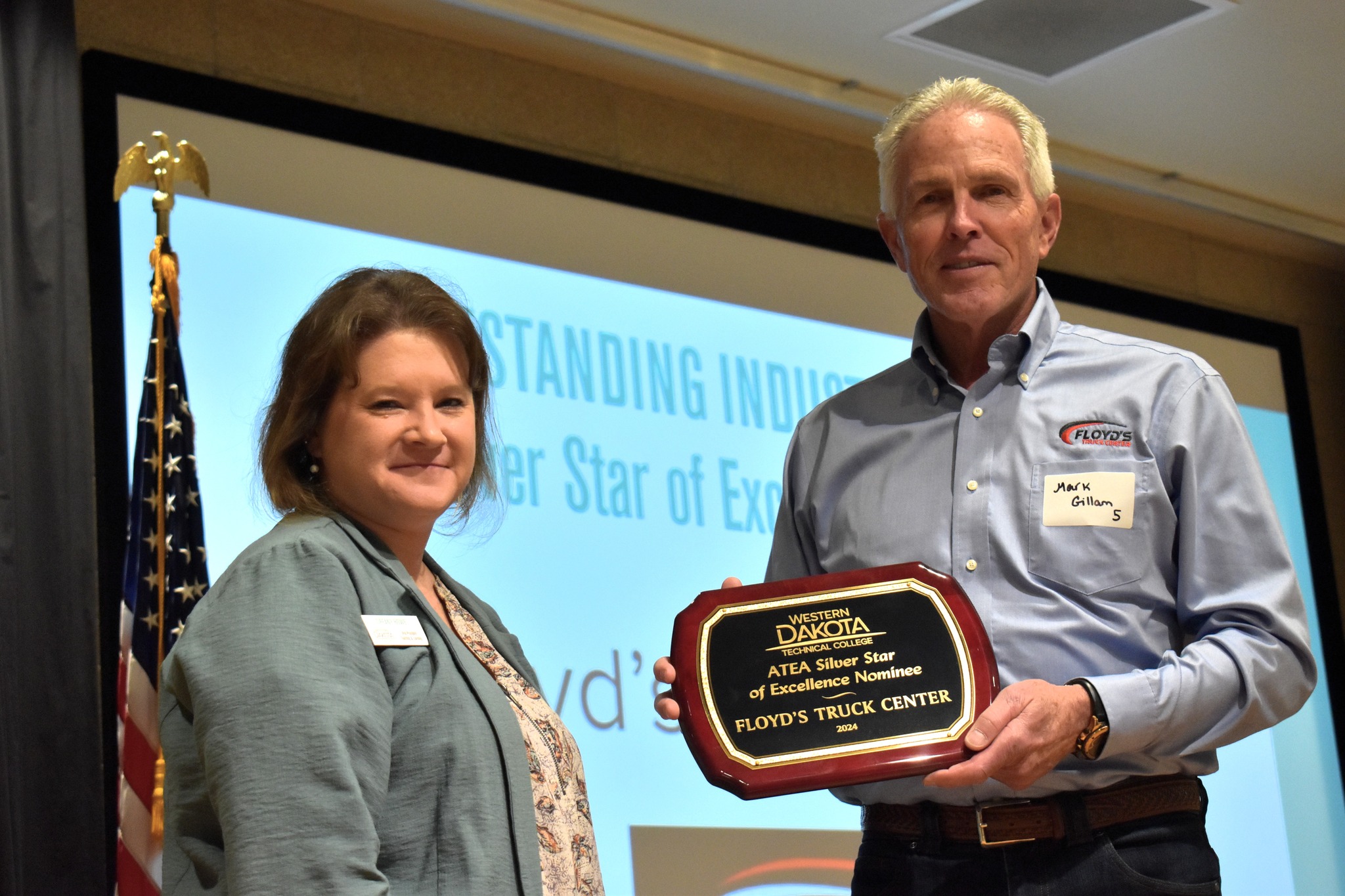 Mark Gillam accepting award for Floyd's Truck Center